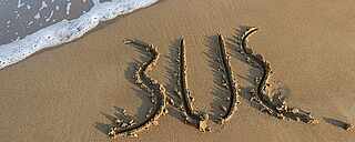 TUI BLUE Logo auf Sand